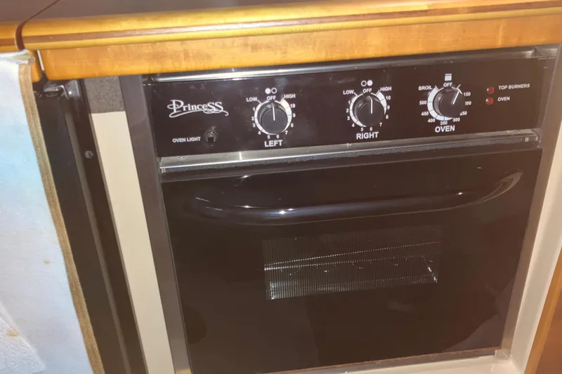Slide: The Image of Princess oven in 2017 Cutwater C-30 Sedan, featuring control knobs and oven light. - 42