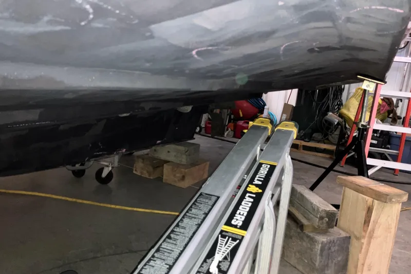 Slide: The Image of 2017 Cutwater C-30 Sedan boat hull in a workshop with Gorilla Ladders. - 113