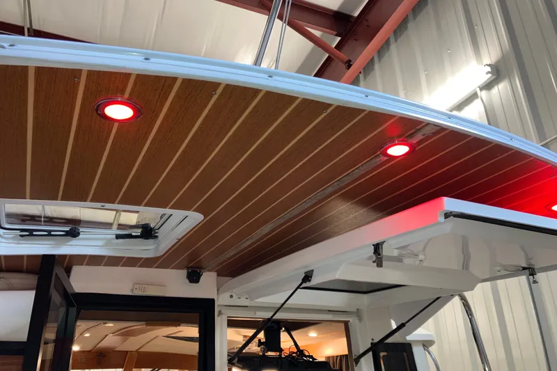 Slide: The Image of 2017 Cutwater C-30 Sedan boat interior with wood ceiling and red LED lights. - 24