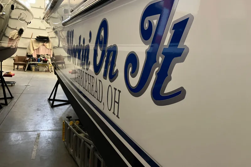 Slide: The Image of 2017 Cutwater C-30 Sedan boat in a garage, featuring "Workin' On It" text. - 106