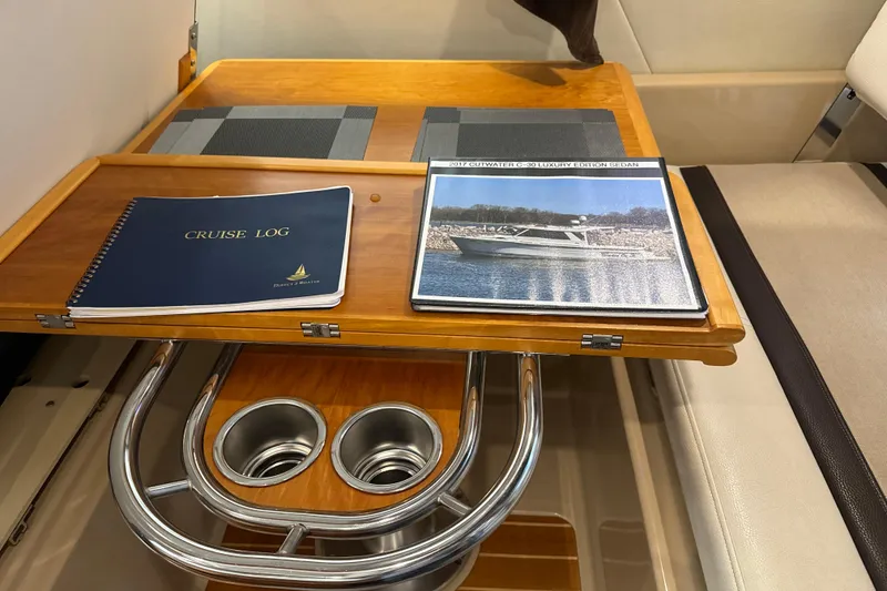 Slide: The Image of Interior of 2017 Cutwater C-30 Sedan with cruise log and brochure on wooden table. - 36