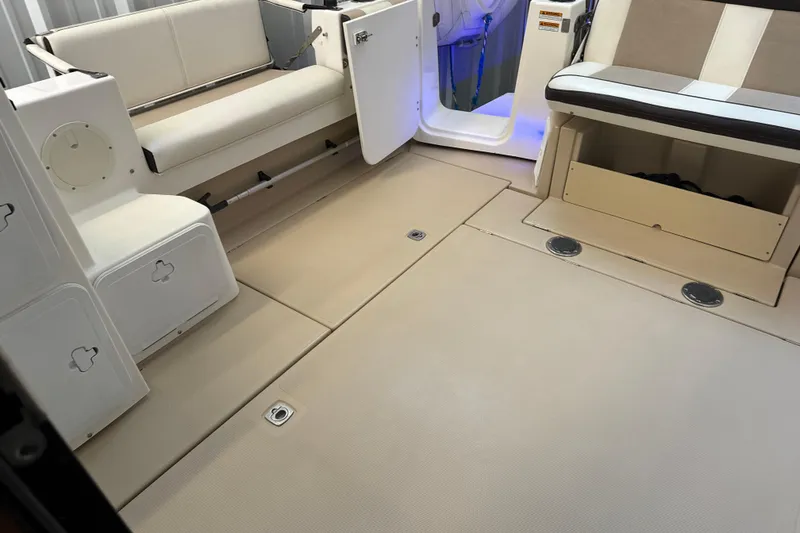 Slide: The Image of 2017 Cutwater C-30 Sedan interior with beige seating and storage compartments. - 13