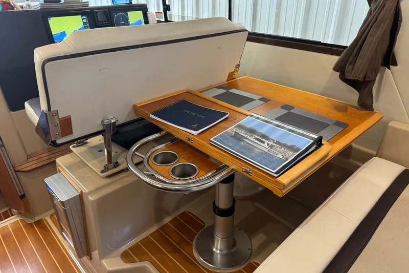 Slide: The Image of Interior of 2017 Cutwater C-30 Sedan with navigation equipment and wooden table setup. - 35