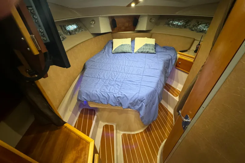 Slide: The Image of 2017 Cutwater C-30 Sedan cabin with cozy bed, wooden flooring, and ambient lighting. - 49