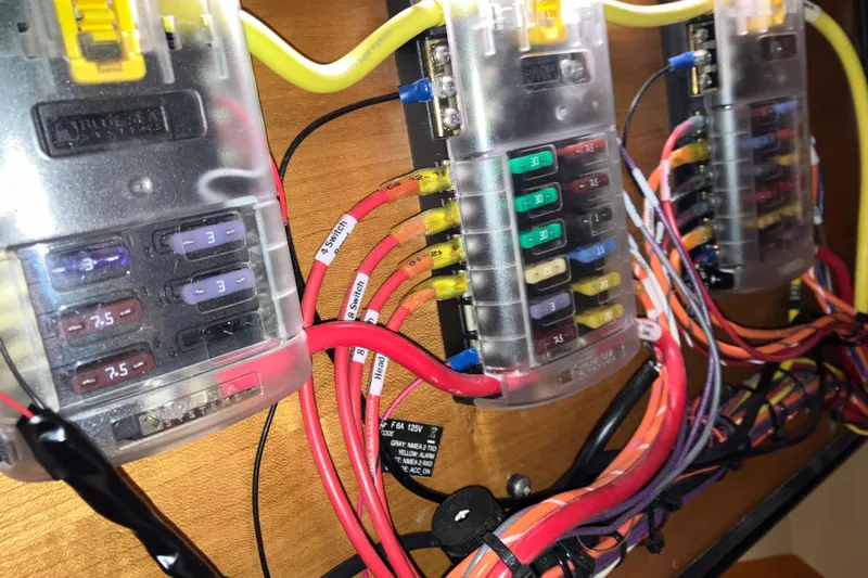 Slide: The Image of Electrical fuse panel with colorful wiring in a 2017 Cutwater C-30 Sedan boat. - 75