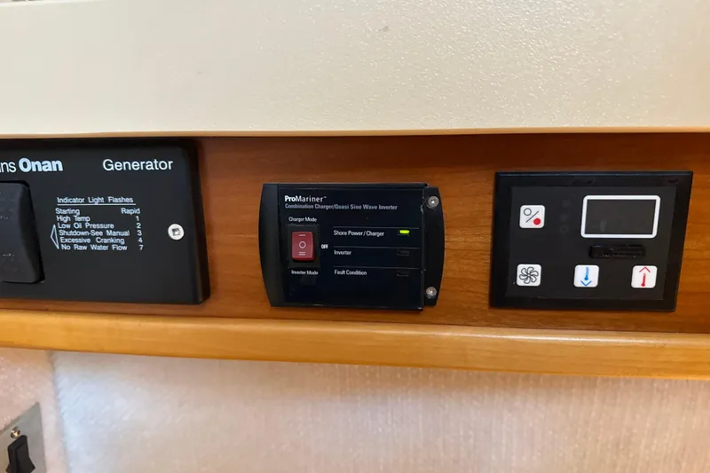 Slide: The Image of Control panel of a 2017 Cutwater C-30 Sedan boat featuring generator and inverter displays. - 28