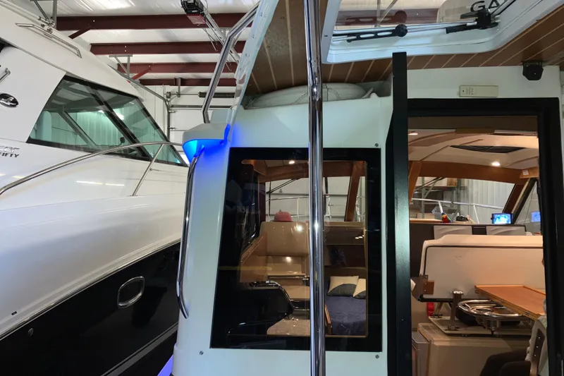 Slide: The Image of 2017 Cutwater C-30 Sedan interior view in a boat storage facility. - 12