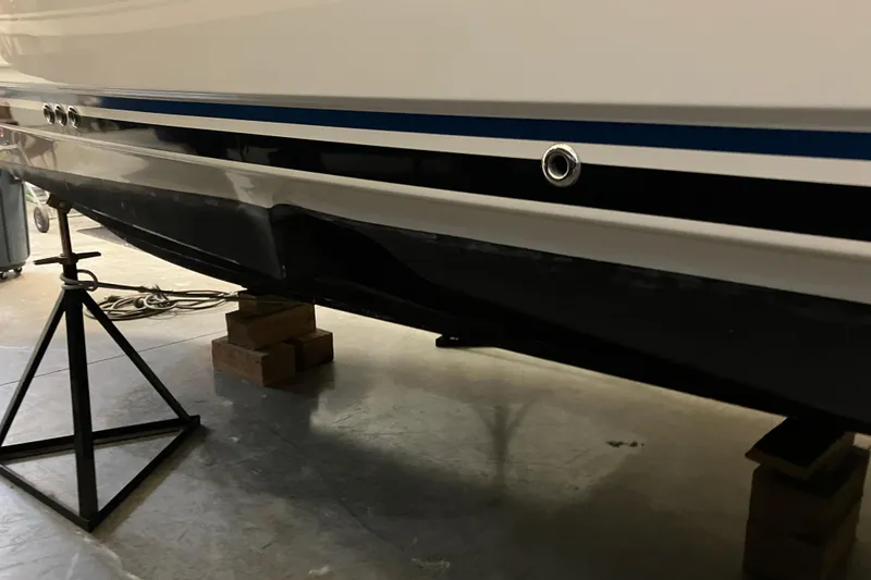 Slide: The Image of 2017 Cutwater C-30 Sedan boat hull on stands in a garage. - 107