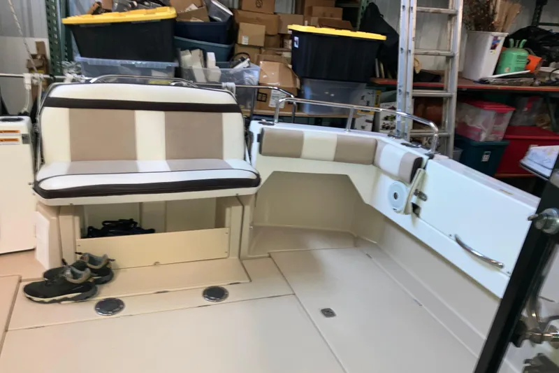 Slide: The Image of 2017 Cutwater C-30 Sedan interior with seating and storage, surrounded by various stored items. - 17