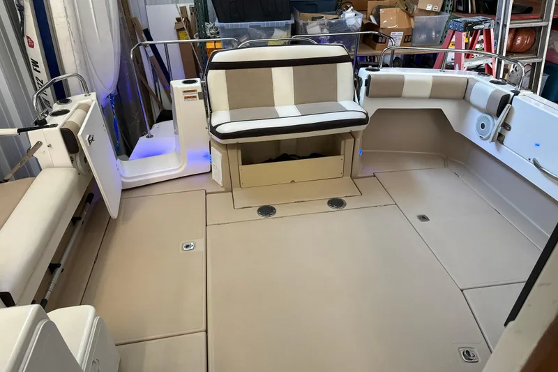 Slide: The Image of 2017 Cutwater C-30 Sedan boat interior with beige seating and storage compartments. - 14