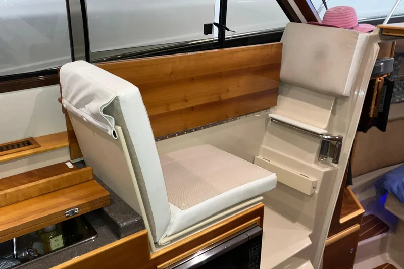 Slide: The Image of 2017 Cutwater C-30 Sedan interior with cushioned seating and wooden accents. - 48