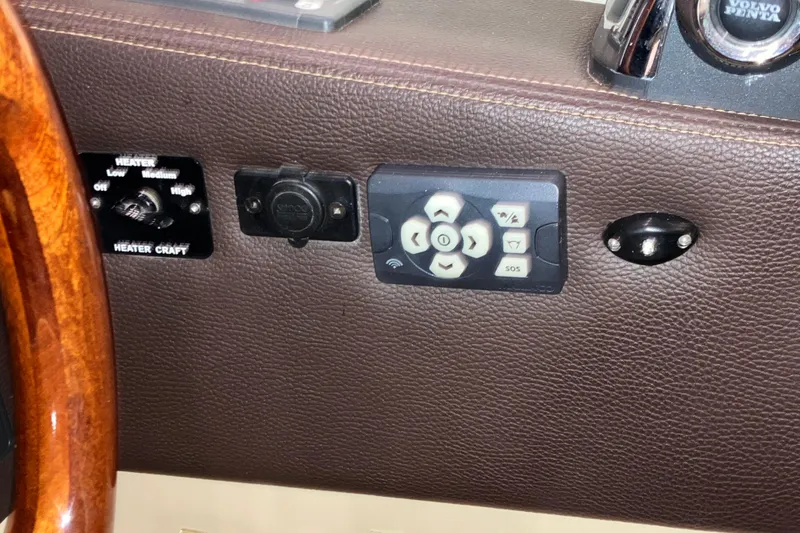 Slide: The Image of 2017 Cutwater C-30 Sedan dashboard with heater controls and remote panel. - 62