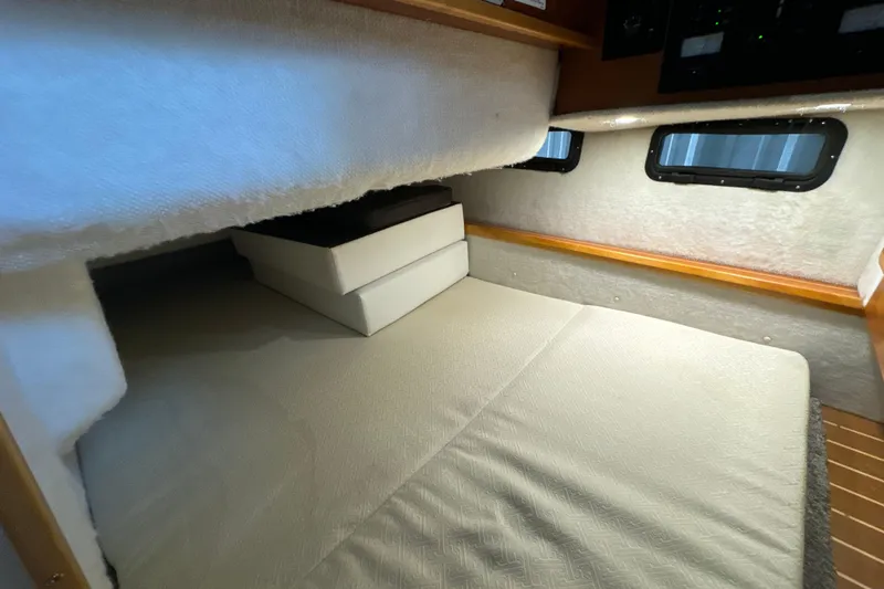 Slide: The Image of 2017 Cutwater C-30 Sedan interior cabin with cozy bed and windows. - 27