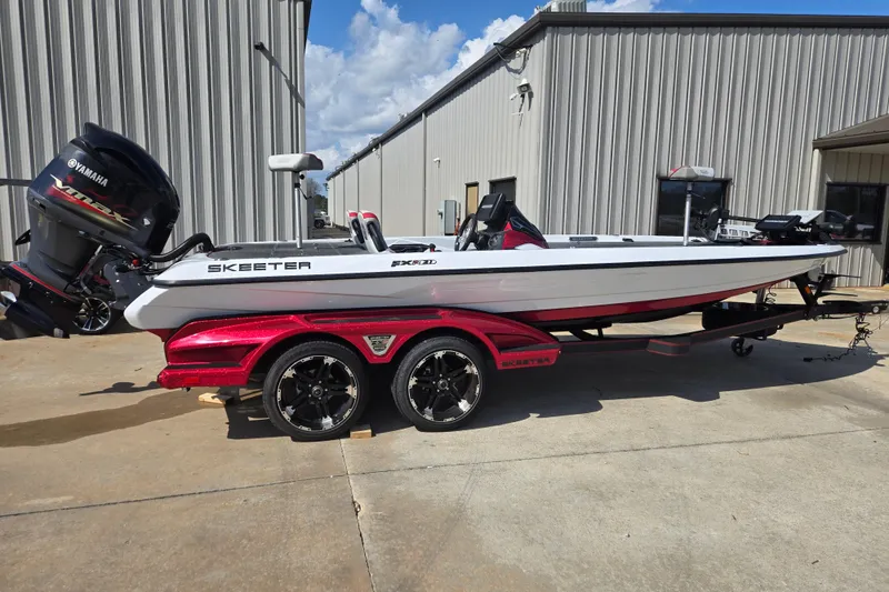 The Image of 2020 Skeeter FXR21 Limited boat on trailer, featuring Yamaha engine, parked outdoors. - 1