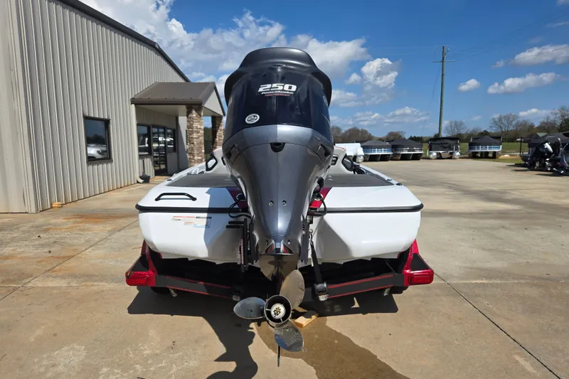 Slide: The Image of 2020 Skeeter FXR21 Limited boat with powerful outboard motor, parked outdoors. - 12