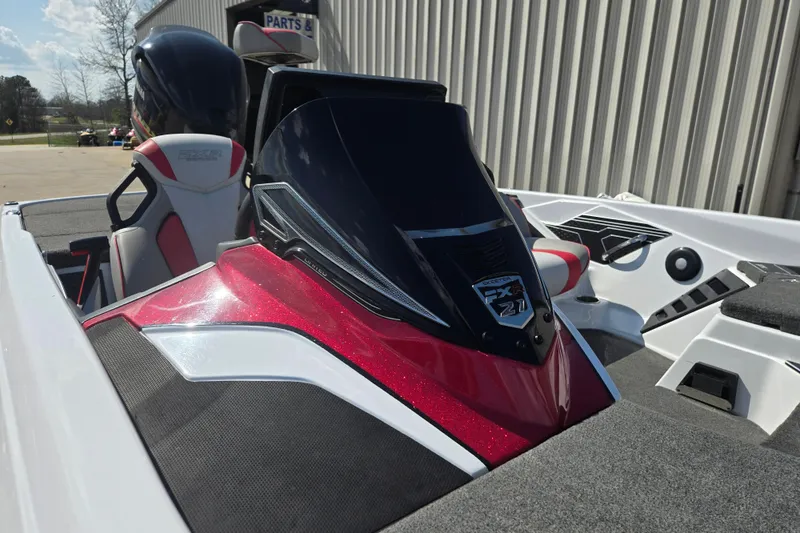 Slide: The Image of 2020 Skeeter FXR21 Limited boat with sleek red and black design, parked outdoors. - 17