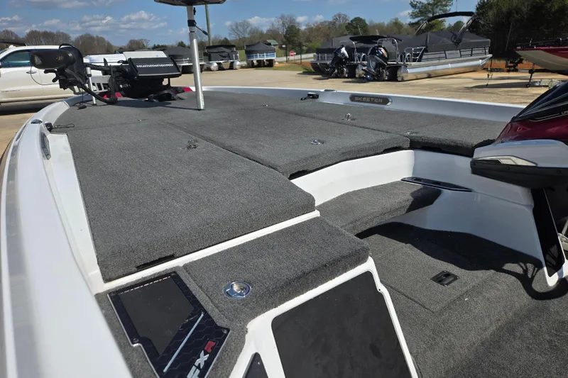 Slide: The Image of 2020 Skeeter FXR21 Limited boat deck with Humminbird electronics, parked outdoors. - 6