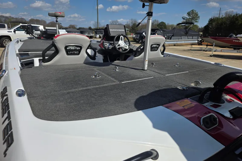 Slide: The Image of 2020 Skeeter FXR21 Limited boat with spacious deck and seating, parked outdoors. - 9