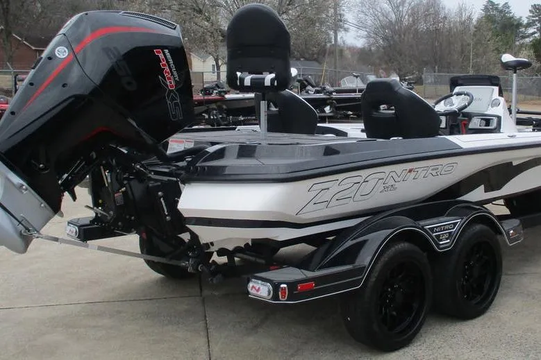 Slide: The Image of 2026 Nitro Z20 XL Pro boat with powerful outboard motor, sleek design, and dual-axle trailer. - 4
