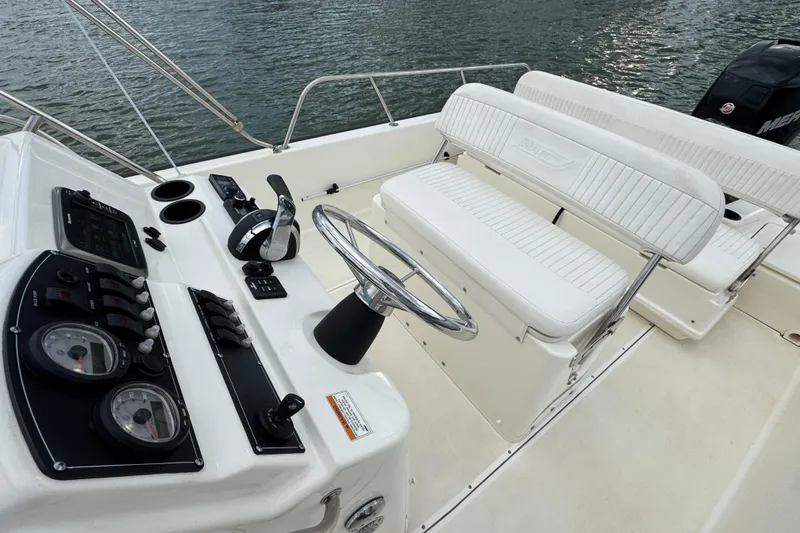 Slide: The Image of 2016 Boston Whaler 210 Montauk boat interior with steering wheel and seating. - 13