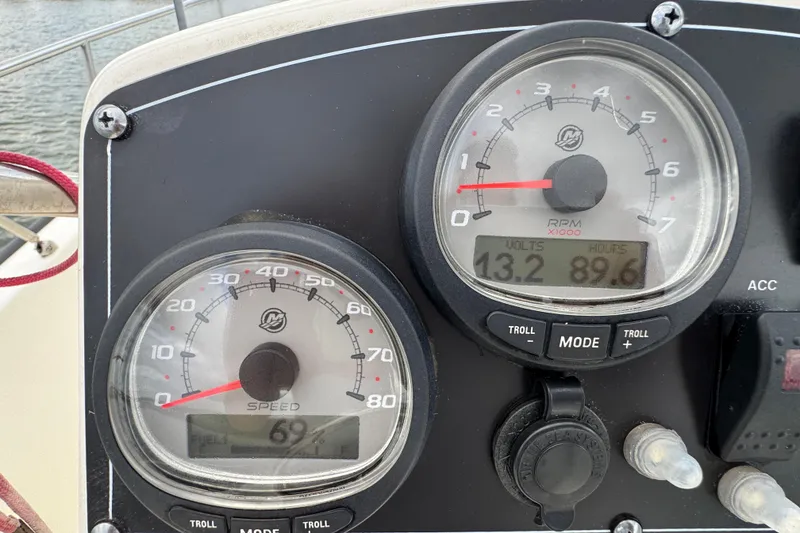 Slide: The Image of Dashboard of a 2016 Boston Whaler 210 Montauk showing speed and RPM gauges. - 16