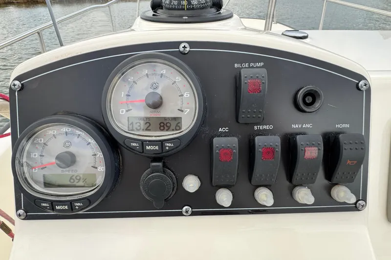 Slide: The Image of Control panel of a 2016 Boston Whaler 210 Montauk boat with gauges and switches. - 17
