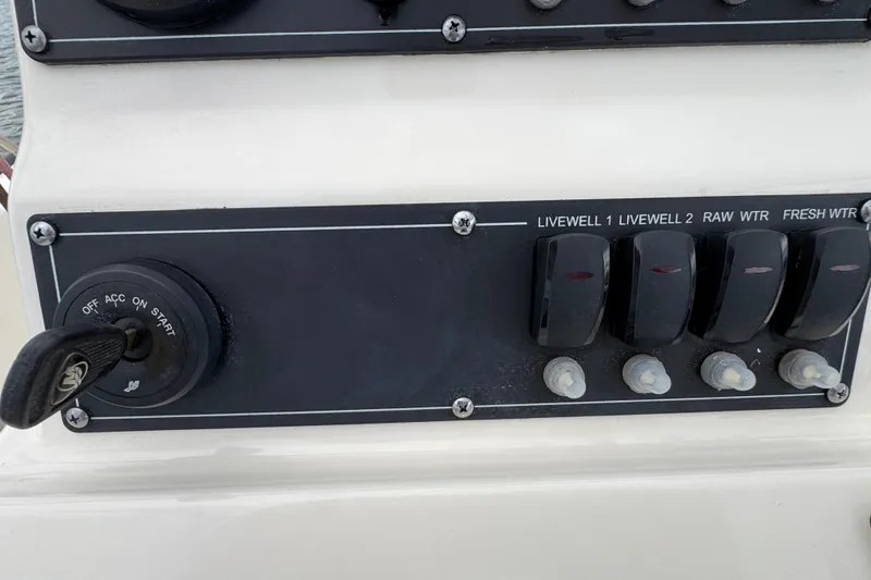 Slide: The Image of Control panel of a 2016 Boston Whaler 210 Montauk boat with switches and ignition. - 18