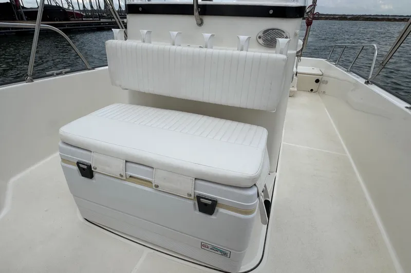 Slide: The Image of 2016 Boston Whaler 210 Montauk boat interior with cushioned seating and cooler. - 27
