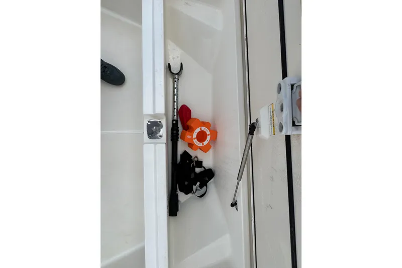 Slide: The Image of Storage compartment of a 2016 Boston Whaler 210 Montauk with boating equipment. - 28