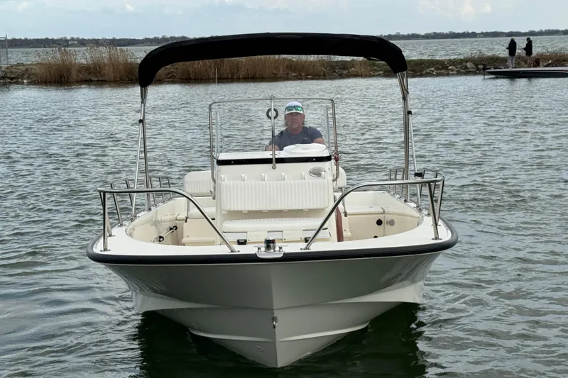 Slide: The Image of 2016 Boston Whaler 210 Montauk boat on water, with canopy and driver. - 3