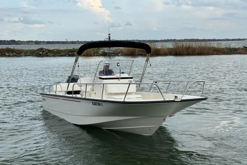 Slide: The Image of 2016 Boston Whaler 210 Montauk boat cruising on a calm lake. - 4