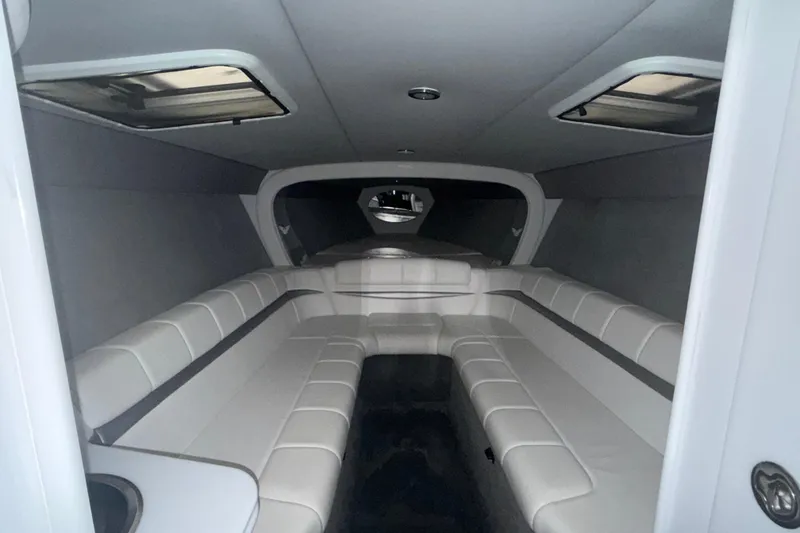 Slide: The Image of Interior of a 2005 Formula 353 FASTech boat, featuring sleek white seating. - 10