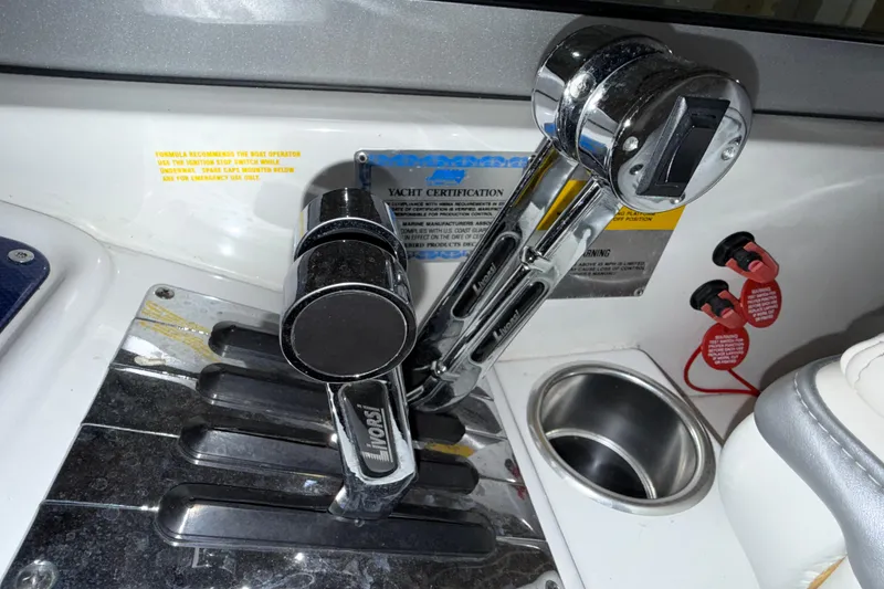 Slide: The Image of Throttle controls on a 2005 Formula 353 FASTech boat dashboard. - 14