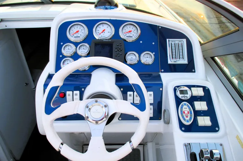 Slide: The Image of 2005 Formula 353 FASTech boat dashboard with gauges, steering wheel, and control panels. - 8