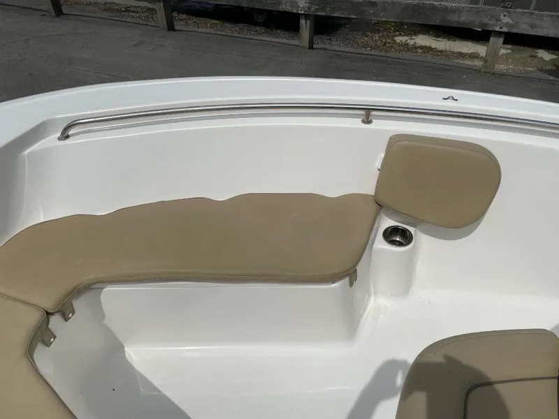 Slide: The Image of 2016 Tidewater 198 Center Console boat interior with beige seating and cup holder. - 20