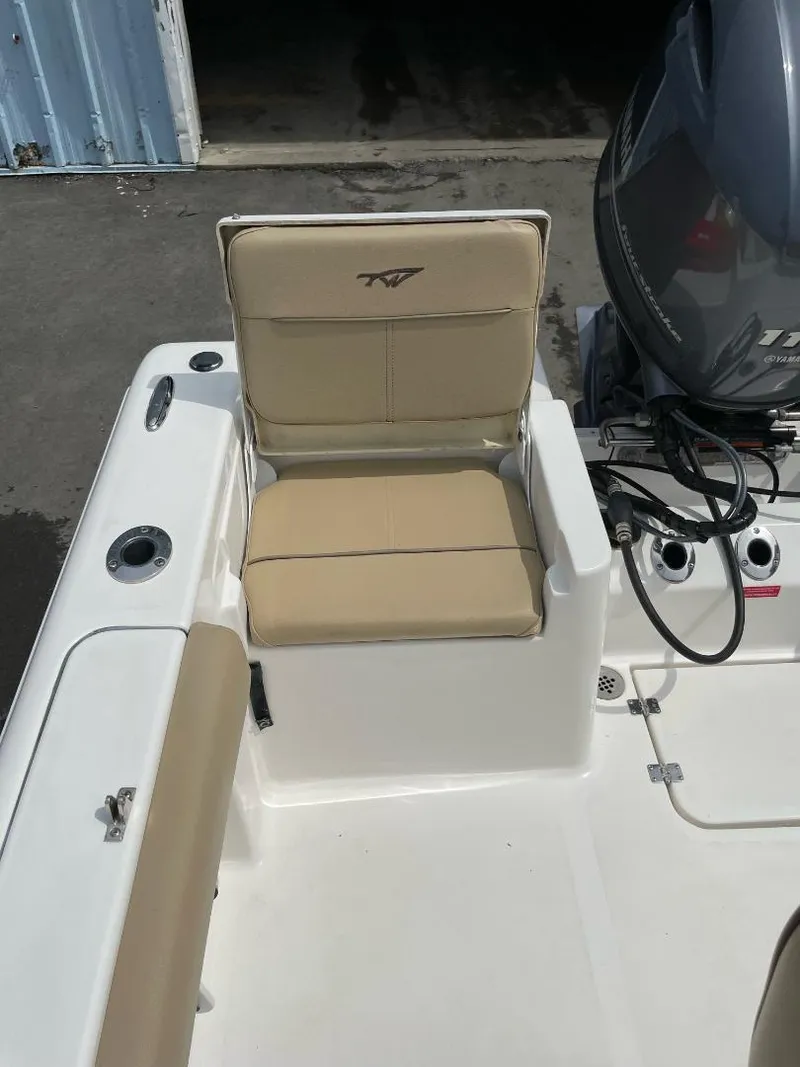Slide: The Image of 2016 Tidewater 198 Center Console boat with beige seating and motor. - 21