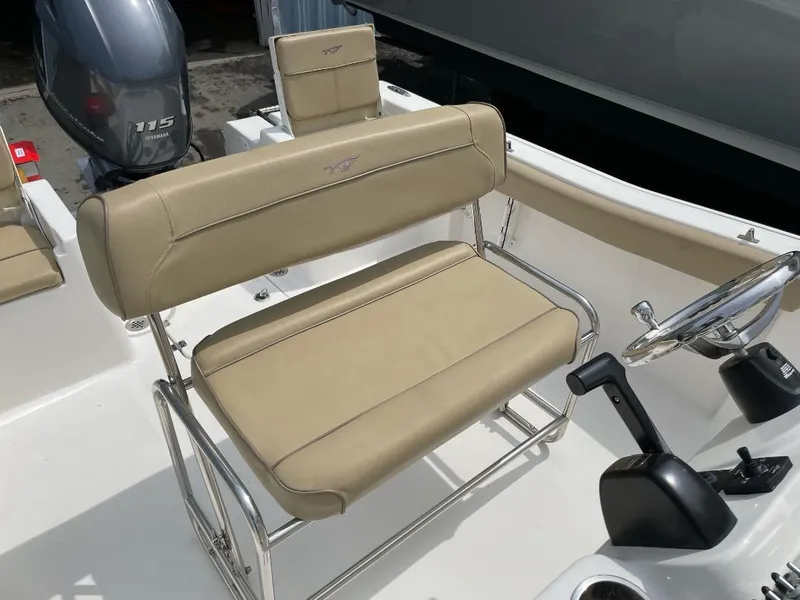 Slide: The Image of 2016 Tidewater 198 Center Console boat interior with beige seating and steering console. - 27