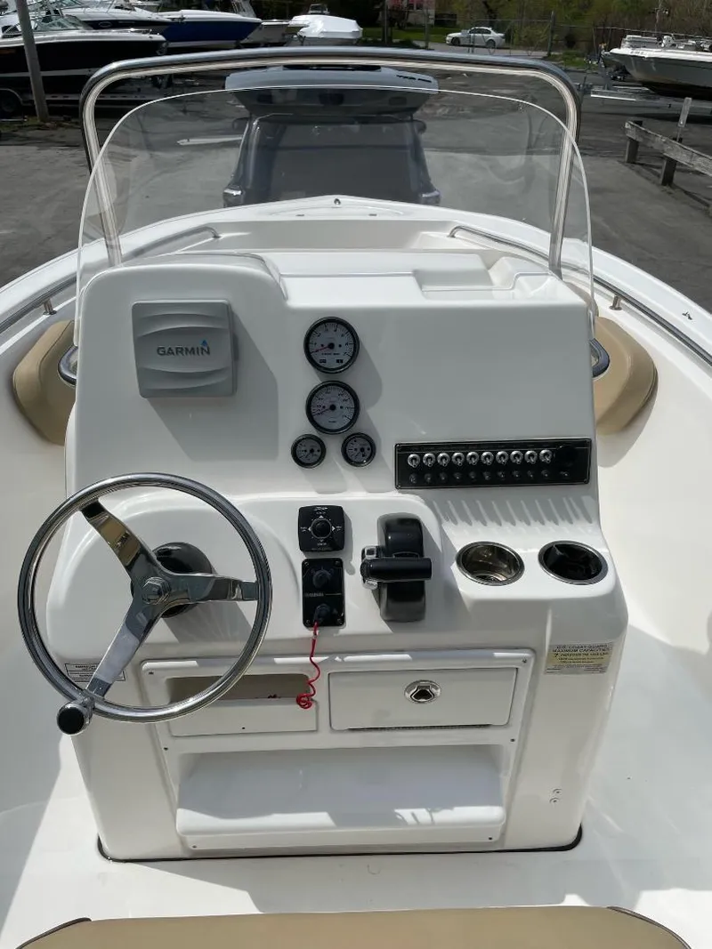 Slide: The Image of 2016 Tidewater 198 Center Console boat dashboard with steering wheel and gauges. - 29