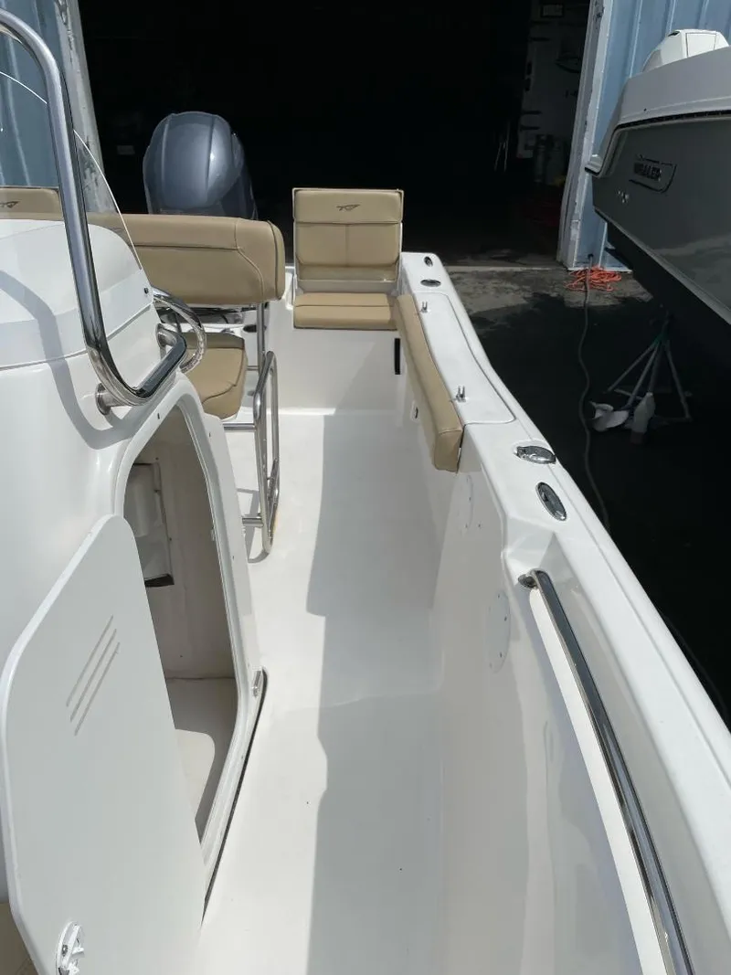 Slide: The Image of 2016 Tidewater 198 Center Console boat interior with beige seating and white deck. - 32