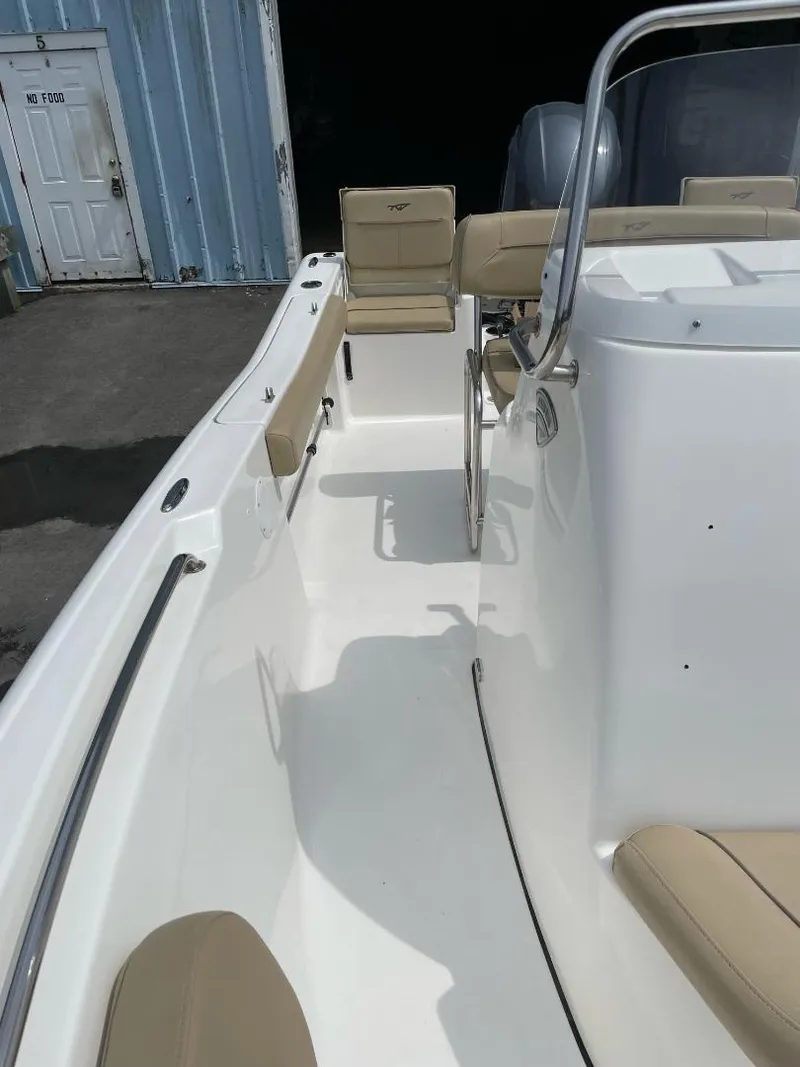 Slide: The Image of 2016 Tidewater 198 Center Console boat interior with beige seating and steering wheel. - 33