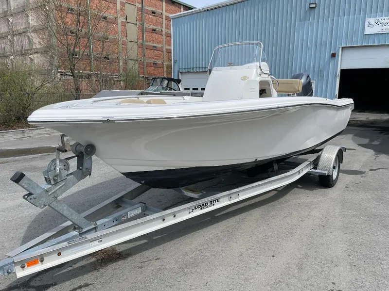 Slide: The Image of 2016 Tidewater 198 Center Console boat on trailer, parked outside industrial building. - 8