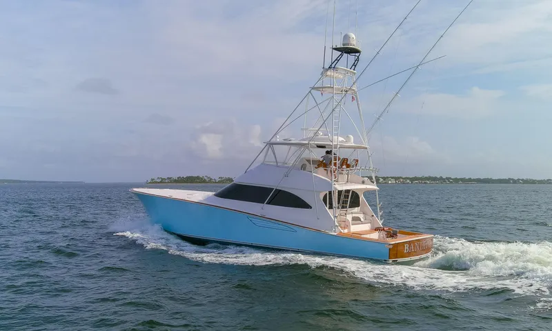 Slide: The Image of 2015 Viking 70 Convertible yacht cruising on open water. - 12