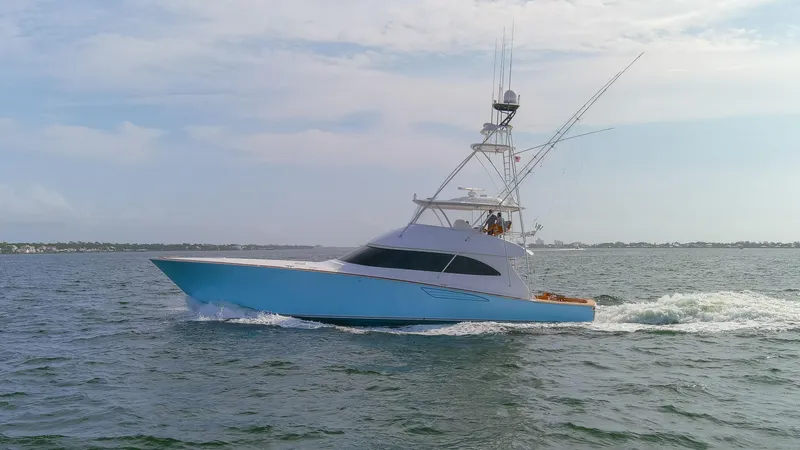 Slide: The Image of 2015 Viking 70 Convertible yacht cruising on open water. - 14