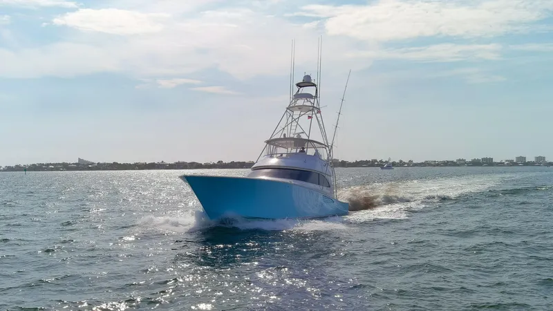 Slide: The Image of 2015 Viking 70 Convertible yacht cruising on open water. - 15