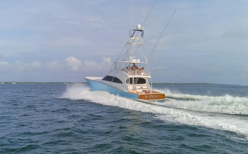 Slide: The Image of 2015 Viking 70 Convertible yacht cruising on open water. - 17