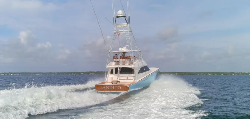 Slide: The Image of 2015 Viking 70 Convertible yacht cruising on open water. - 18