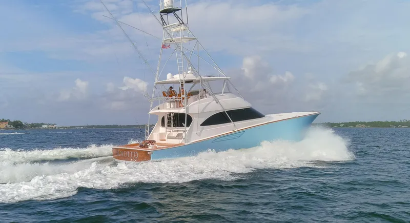 Slide: The Image of 2015 Viking 70 Convertible yacht cruising on open water. - 19
