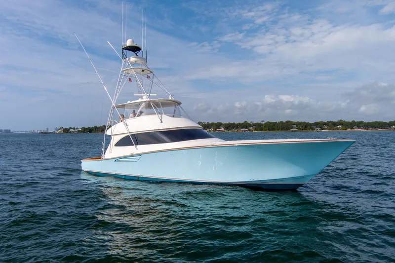 Slide: The Image of 2015 Viking 70 Convertible yacht on open water under blue sky. - 2