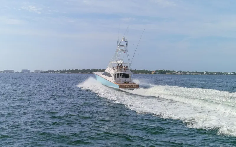 Slide: The Image of 2015 Viking 70 Convertible yacht cruising on open water. - 26