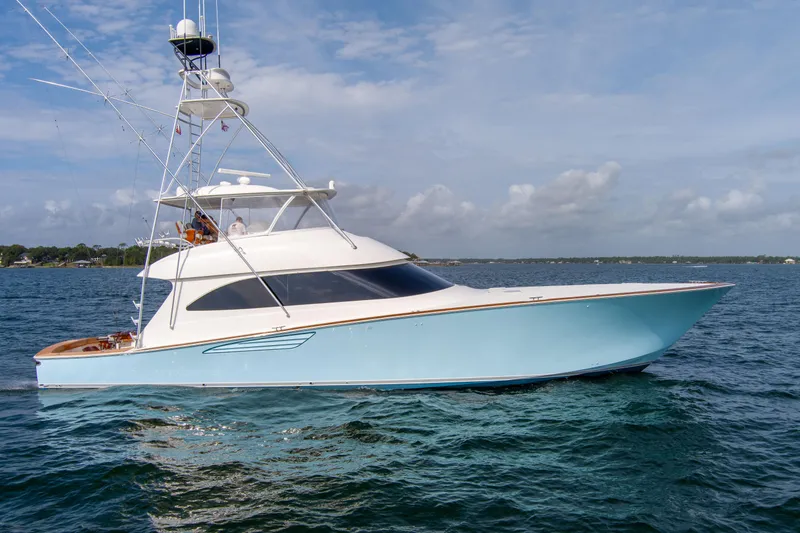 Slide: The Image of 2015 Viking 70 Convertible yacht on open water under blue sky. - 3